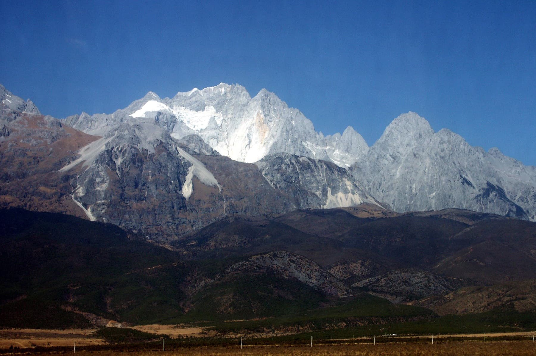 Yulong Snow Mountain rising above a calm pool in Lijiang