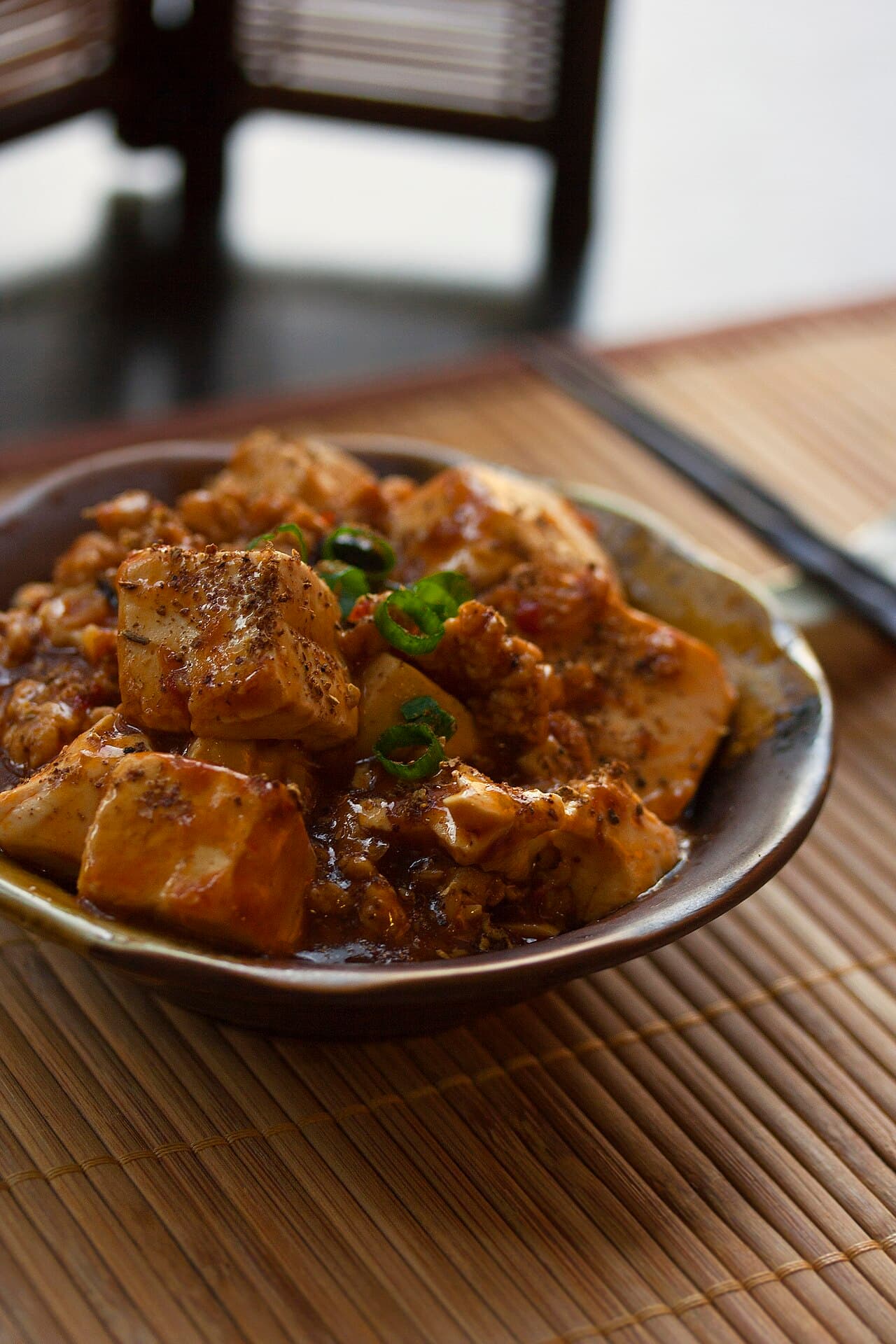 Cubes of tofu in a red chilli-oil sauce with minced meat and spring onion